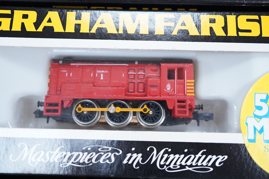 Four boxed Graham Farish N gauge railway Class 08 0-6-0 diesel locomotives; a BR, D3729 (371-001), a Railfreight Distribution, 08 653 (371-000), an EWS, 08957 (100F) and a Thomas 1, 08500 (1006).
